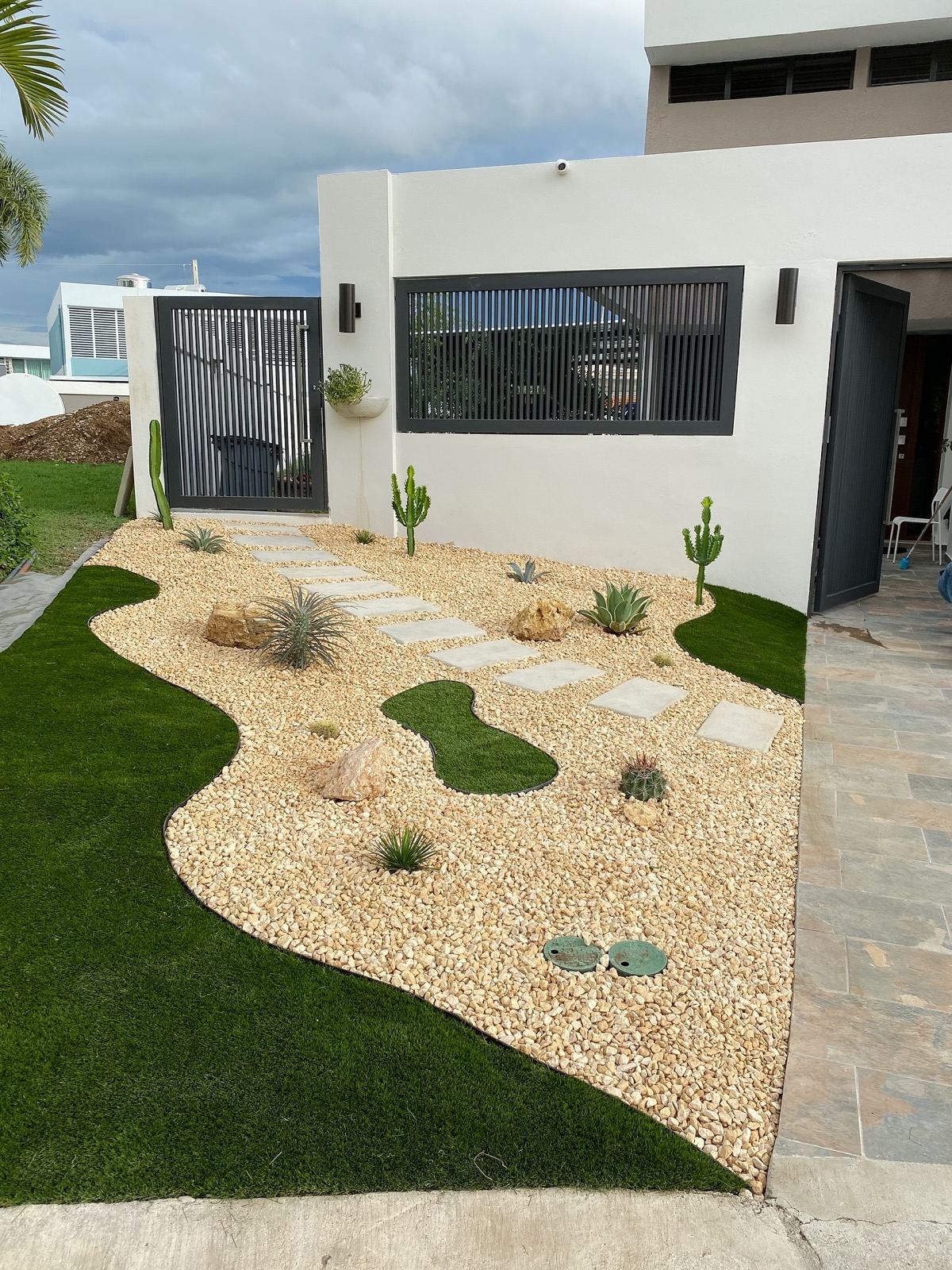 Stepping-stone path through golden gravel and cactus